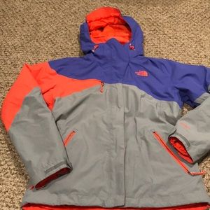 Woman’s purple / orange / grey north face jacket